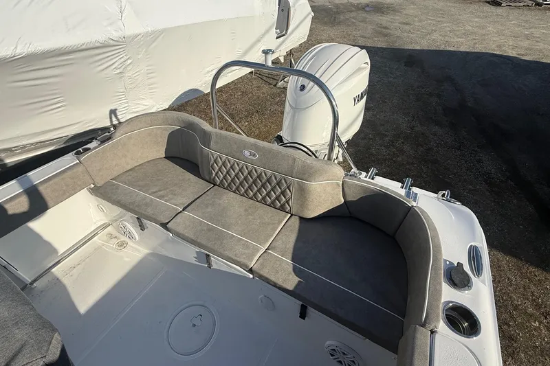 Slide: The Image of 2026 Sea Hunt Ultra 229 boat interior with cushioned seating and Yamaha outboard motor. - 12