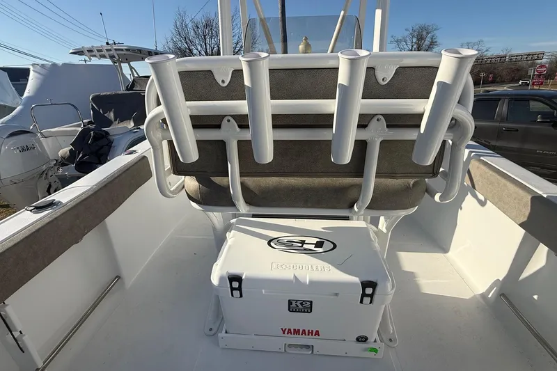 Slide: The Image of 2026 Sea Hunt Ultra 229 boat interior with rod holders and Yamaha cooler. - 14