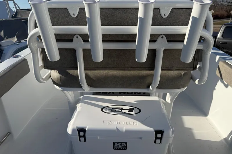 Slide: The Image of 2026 Sea Hunt Ultra 229 boat interior with rod holders and K2 cooler. - 26