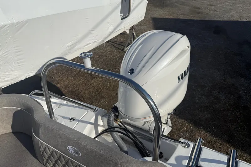 Slide: The Image of 2026 Sea Hunt Ultra 229 boat with Yamaha outboard motor, rear seating, and stainless steel railing. - 6