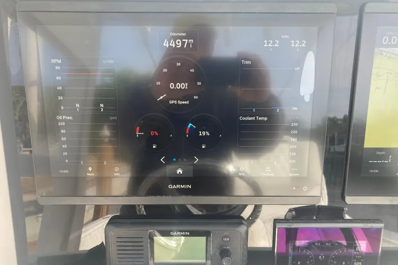 Slide: The Image of Garmin display on 2020 Invincible 33 Open Fisherman showing odometer and engine metrics. - 10