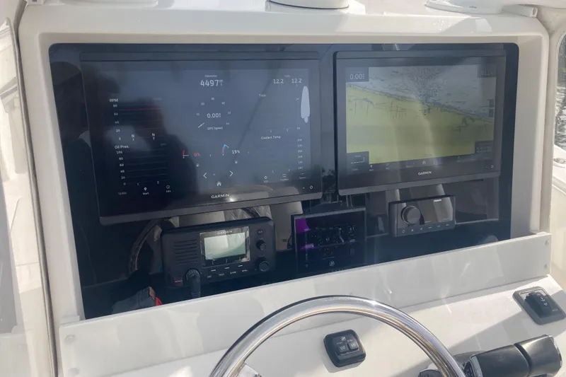 Slide: The Image of Dashboard of 2020 Invincible 33 Open Fisherman with Garmin navigation displays. - 12
