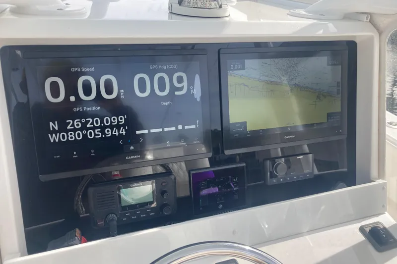 Slide: The Image of Dashboard of a 2020 Invincible 33 Open Fisherman with Garmin navigation displays. - 17