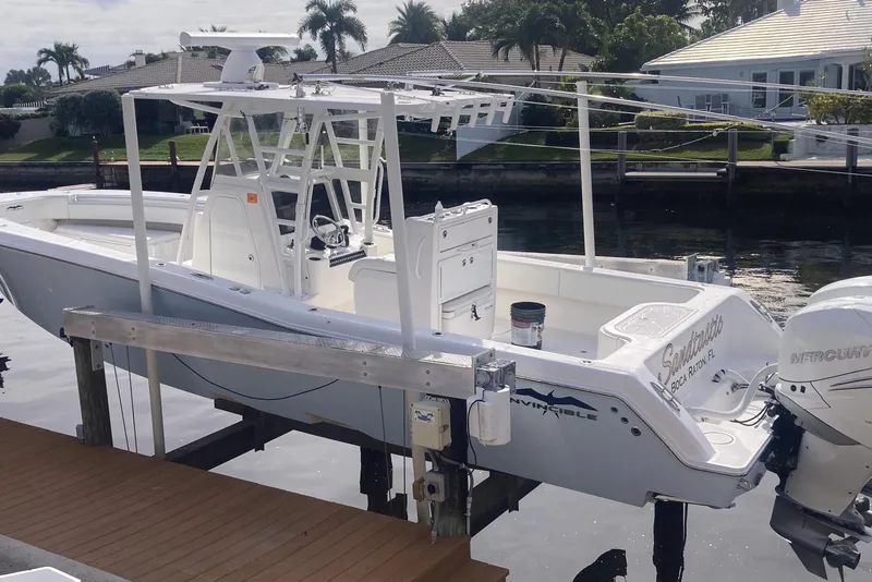 Slide: The Image of 2020 Invincible 33 Open Fisherman boat docked by waterfront homes. - 2