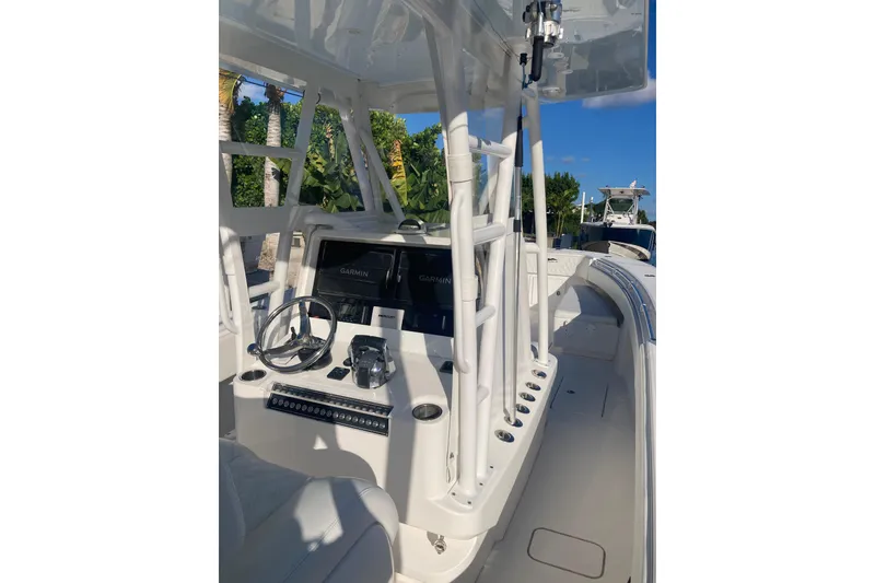 Slide: The Image of 2020 Invincible 33 Open Fisherman boat interior with steering wheel and navigation system. - 20