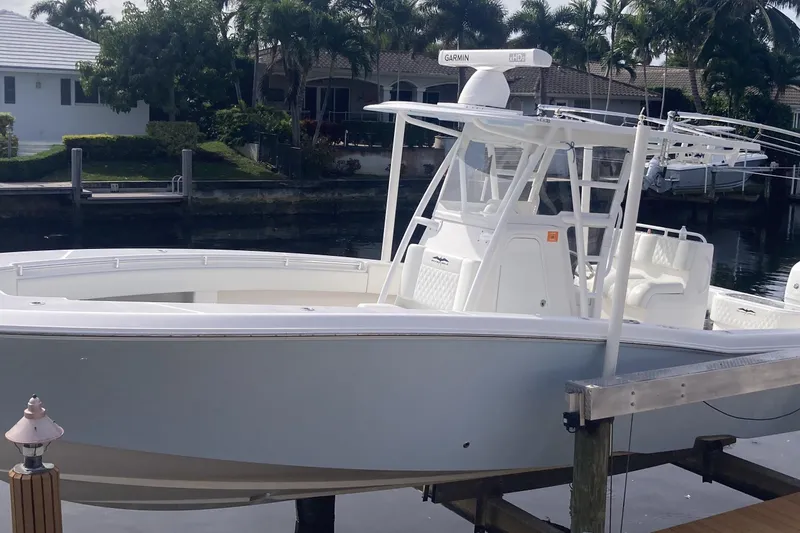 Slide: The Image of 2020 Invincible 33 Open Fisherman boat docked by waterfront homes. - 23