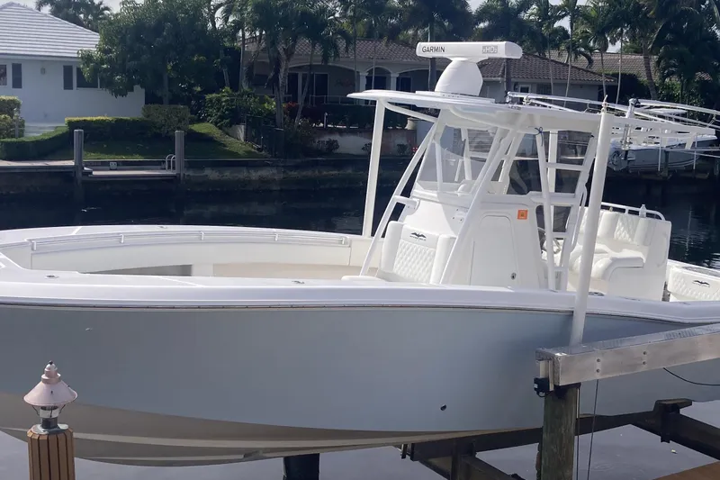 Slide: The Image of 2020 Invincible 33 Open Fisherman boat docked by waterfront homes. - 24