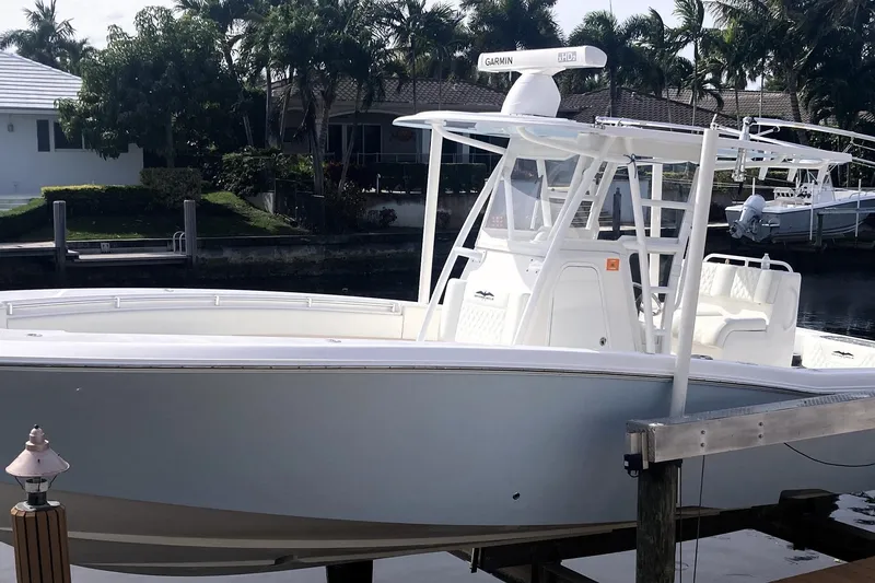 Slide: The Image of 2020 Invincible 33 Open Fisherman boat docked near waterfront homes. - 25