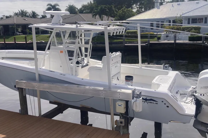 Slide: The Image of 2020 Invincible 33 Open Fisherman boat docked by waterfront homes. - 3