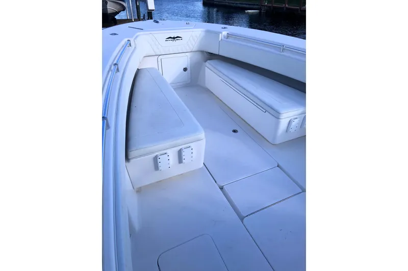 Slide: The Image of 2020 Invincible 33 Open Fisherman boat interior with white seating and storage compartments. - 30