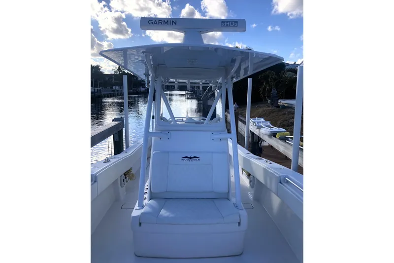 Slide: The Image of 2020 Invincible 33 Open Fisherman boat docked by the water, featuring Garmin equipment. - 33