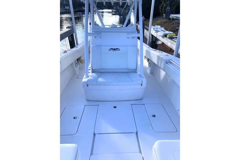 Slide: The Image of 2020 Invincible 33 Open Fisherman boat interior with white seating and storage compartments. - 34