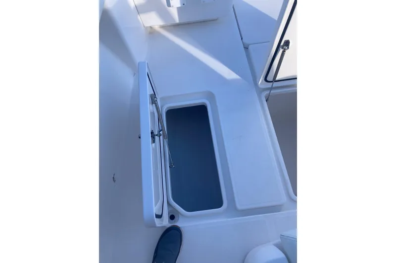 Slide: The Image of 2020 Invincible 33 Open Fisherman boat deck with open storage compartment. - 37