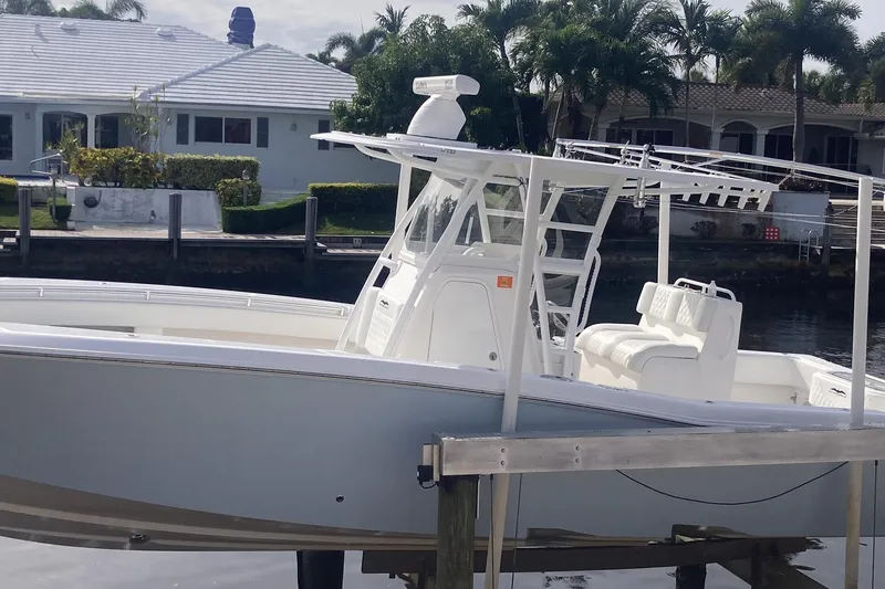 Slide: The Image of 2020 Invincible 33 Open Fisherman boat docked near waterfront homes. - 4