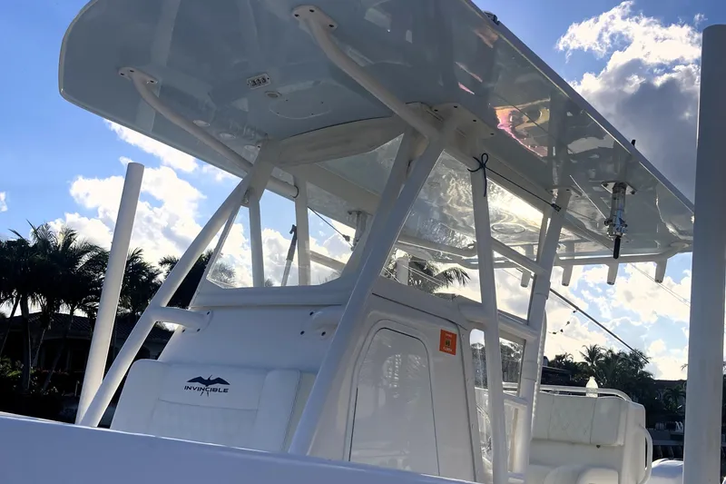 Slide: The Image of 2020 Invincible 33 Open Fisherman boat with T-top against a sunny sky. - 41