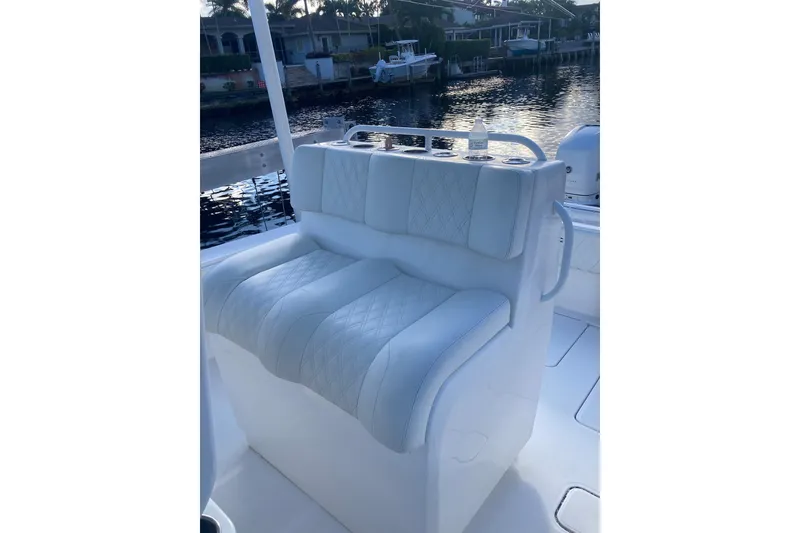 Slide: The Image of 2020 Invincible 33 Open Fisherman boat with white cushioned seating by the water. - 44