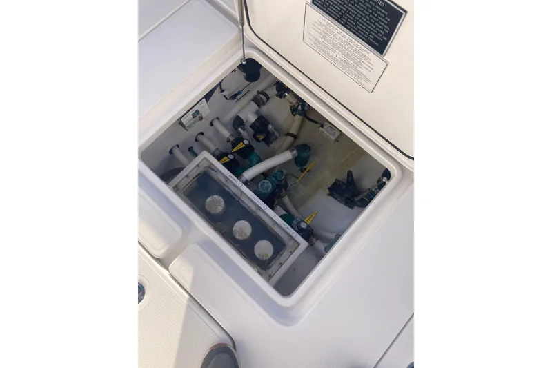 Slide: The Image of 2020 Invincible 33 Open Fisherman boat compartment with visible plumbing and equipment. - 45