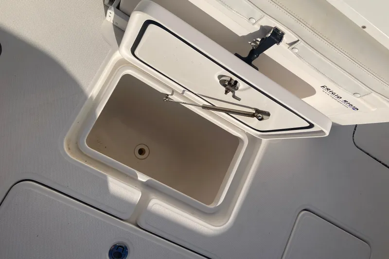 Slide: The Image of Open storage compartment on 2020 Invincible 33 Open Fisherman boat deck. - 46