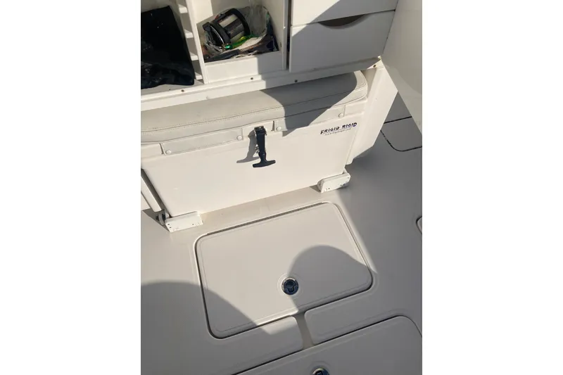 Slide: The Image of 2020 Invincible 33 Open Fisherman boat interior with storage compartments and cooler. - 51
