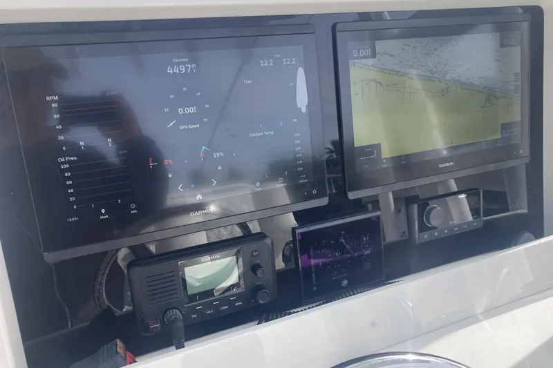 Slide: The Image of Dashboard of 2020 Invincible 33 Open Fisherman with Garmin navigation displays. - 8