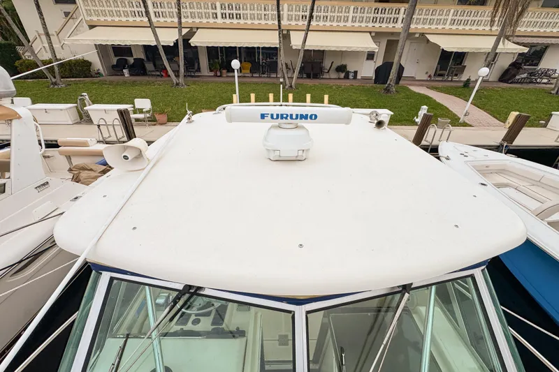 Slide: The Image of 2002 Pursuit 3000 Express boat docked, featuring Furuno radar on the roof. - 103
