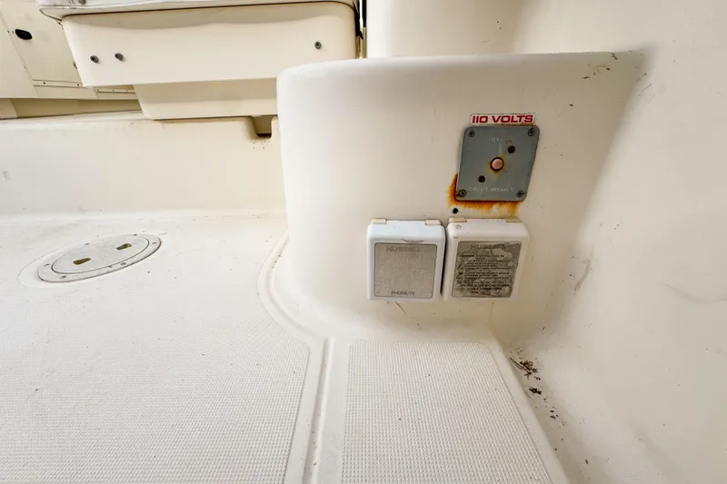 Slide: The Image of 2002 Pursuit 3000 Express boat interior with electrical outlets and circuit breaker. - 113