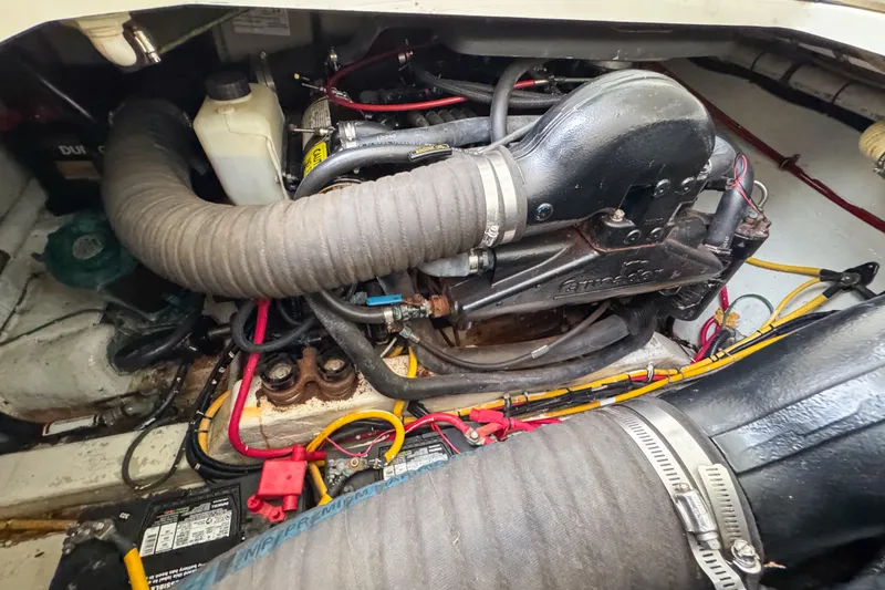Slide: The Image of Engine compartment of a 2002 Pursuit 3000 Express boat, showing detailed components and wiring. - 121