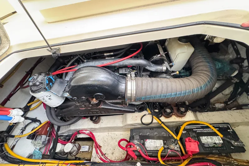 Slide: The Image of Engine compartment of a 2002 Pursuit 3000 Express boat, showcasing wiring and components. - 122