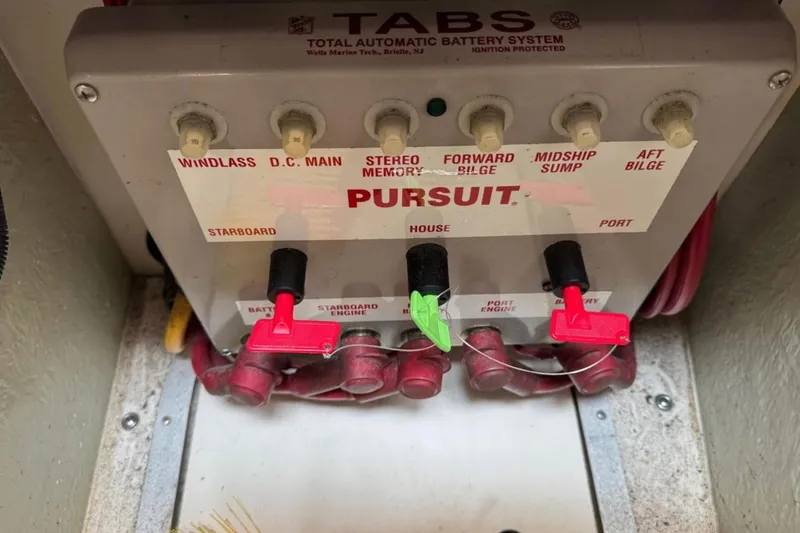 Slide: The Image of Control panel of a 2002 Pursuit 3000 Express boat's automatic battery system. - 123