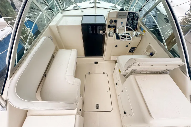 Slide: The Image of 2002 Pursuit 3000 Express boat interior with helm, seating, and control panel. - 21