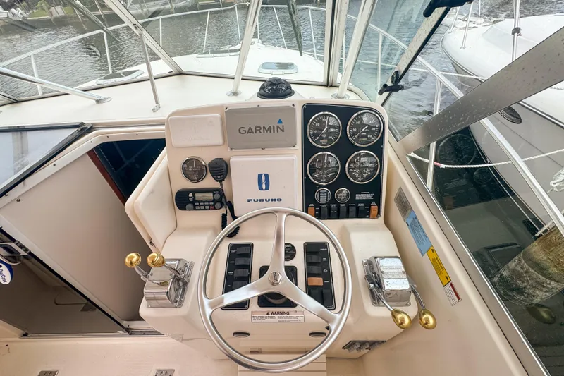 Slide: The Image of Helm of 2002 Pursuit 3000 Express boat with Garmin and Furuno navigation systems. - 34