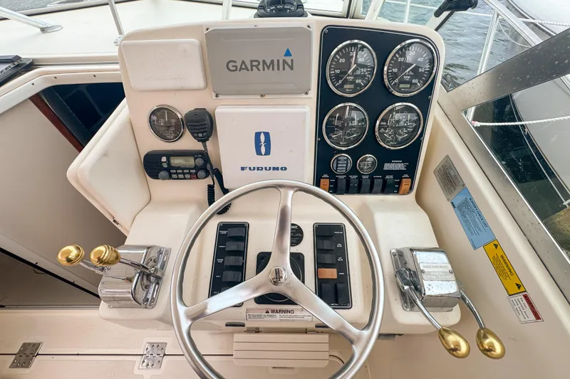 Slide: The Image of 2002 Pursuit 3000 Express boat helm with Garmin and Furuno navigation systems. - 36