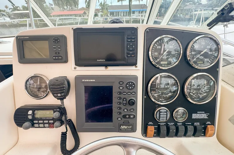 Slide: The Image of Control panel of a 2002 Pursuit 3000 Express boat with navigation instruments. - 37
