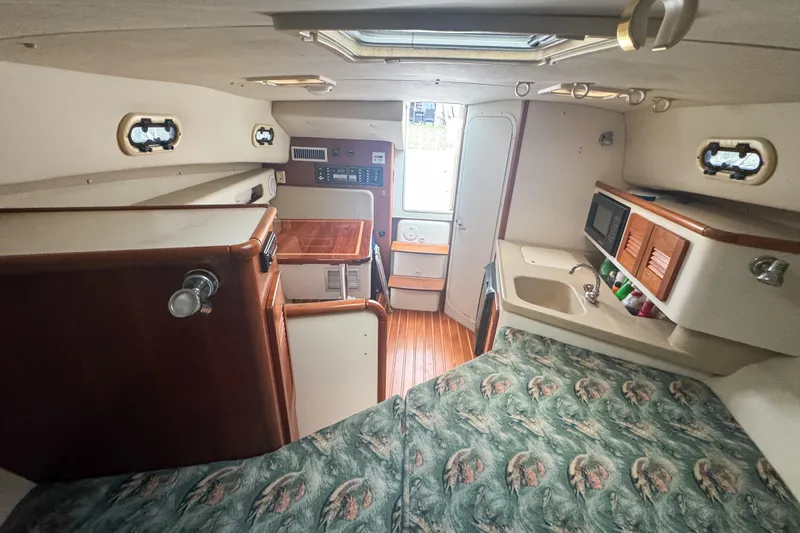 Slide: The Image of Interior of 2002 Pursuit 3000 Express boat with kitchenette and cozy sleeping area. - 47