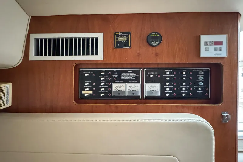 Slide: The Image of Control panel of a 2002 Pursuit 3000 Express boat with gauges and switches. - 62