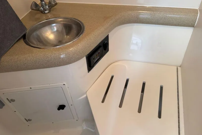 Slide: The Image of 2002 Pursuit 3000 Express boat interior with sink and countertop. - 70