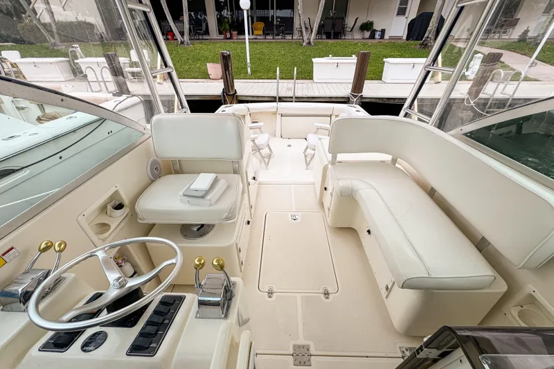 Slide: The Image of 2002 Pursuit 3000 Express boat interior with helm, seating, and controls. - 73