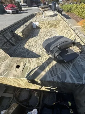 Slide: The Image of 2025 Crestliner 1860 Retriever Jon Deluxe boat with camouflage design and seating. - 5