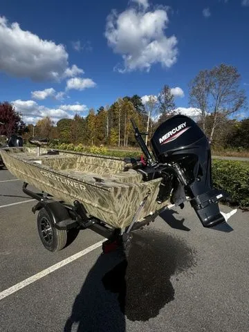 Slide: The Image of 2025 Crestliner 1860 Retriever Jon Deluxe boat with Mercury engine, parked outdoors. - 3