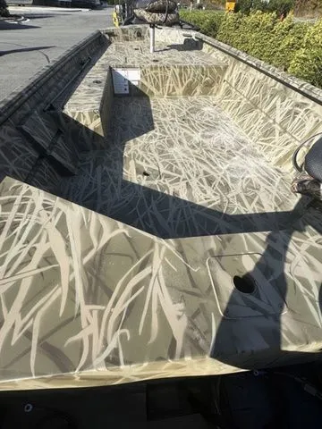 Slide: The Image of 2025 Crestliner 1860 Retriever Jon Deluxe boat with camouflage interior design. - 4