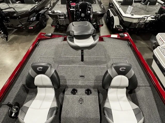 Slide: The Image of 2025 Crestliner XFC 179 boat interior with seating and motor, displayed in showroom. - 12