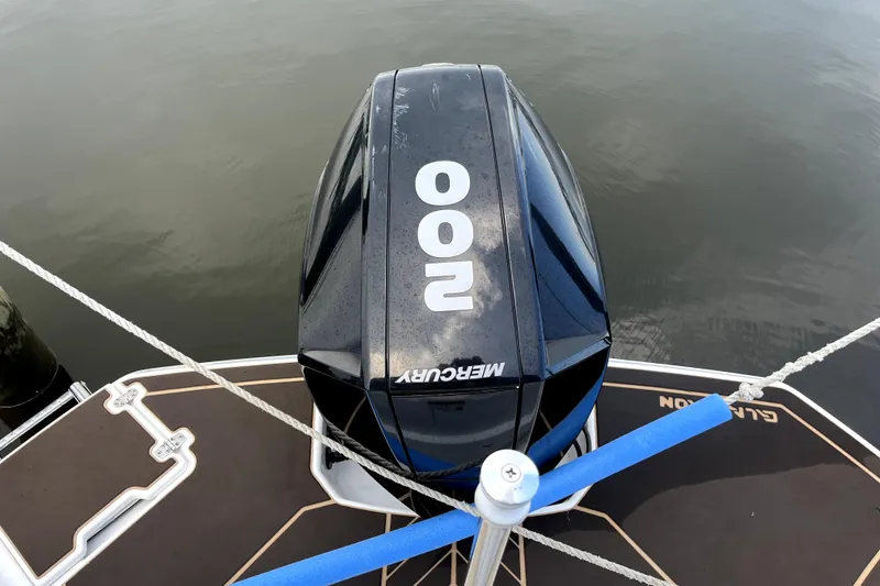 Slide: The Image of 2022 Glastron GTD 220 boat with Mercury 200 engine on calm water. - 9