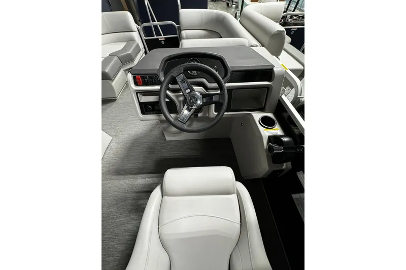 Slide: The Image of 2025 Godfrey Xperience 1886 CX boat interior with steering wheel and seating. - 6