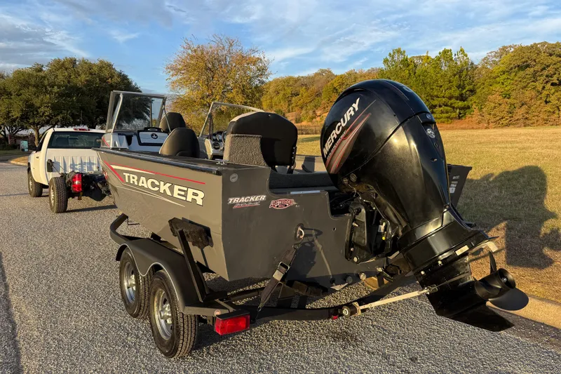 Slide: The Image of 2018 Tracker Targa 18 WT boat on trailer, parked outdoors with Mercury engine. - 10