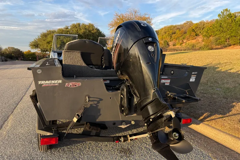 Slide: The Image of 2018 Tracker Targa 18 WT boat on trailer, parked outdoors under clear sky. - 11