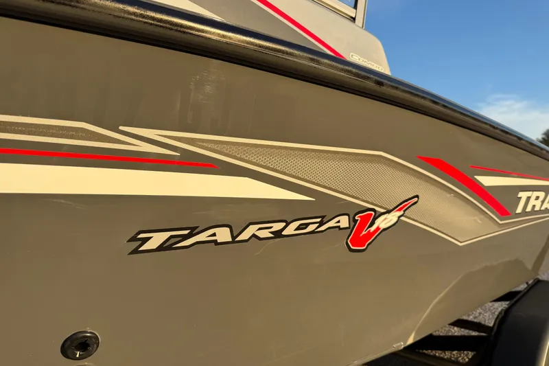 Slide: The Image of 2018 Tracker Targa 18 WT boat with red and white graphics on a sunny day. - 16
