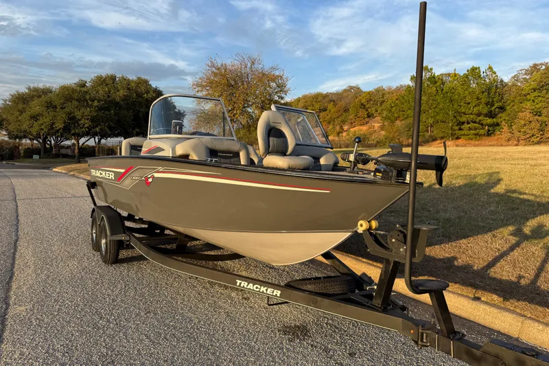Slide: The Image of 2018 Tracker Targa 18 WT boat on trailer, parked outdoors under clear sky. - 20
