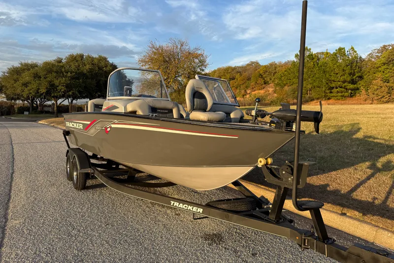 Slide: The Image of 2018 Tracker Targa 18 WT boat on trailer, parked outdoors with trees in background. - 21