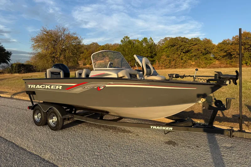 Slide: The Image of 2018 Tracker Targa 18 WT boat with Mercury engine on trailer, parked outdoors. - 23