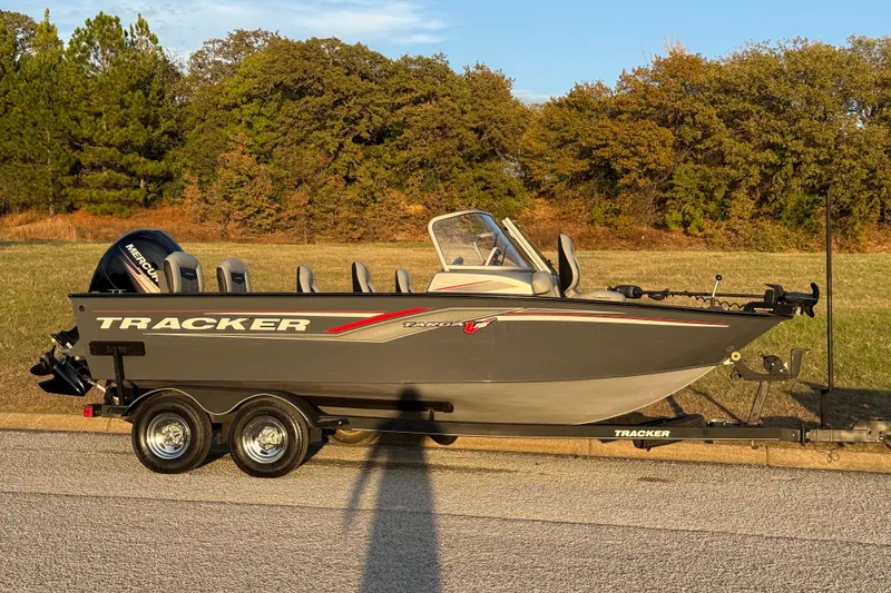 Slide: The Image of 2018 Tracker Targa 18 WT boat with Mercury engine on trailer, parked outdoors. - 24